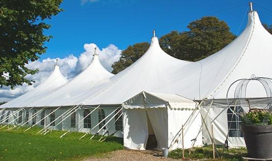 a group of luxury portable restrooms with individual stalls and running water in Howells NE